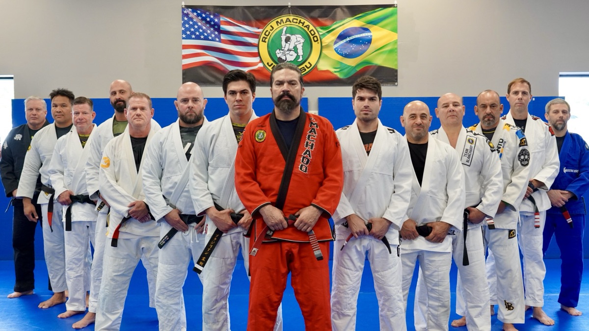 John with his father, Master John Machado, his brother, Jean, and fellow black belts of the Machado Team
