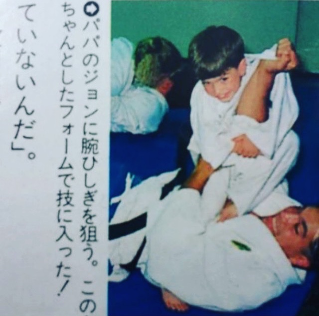 Young John going for an armbar on his father in a Japanese martial arts magazine, early 1990s