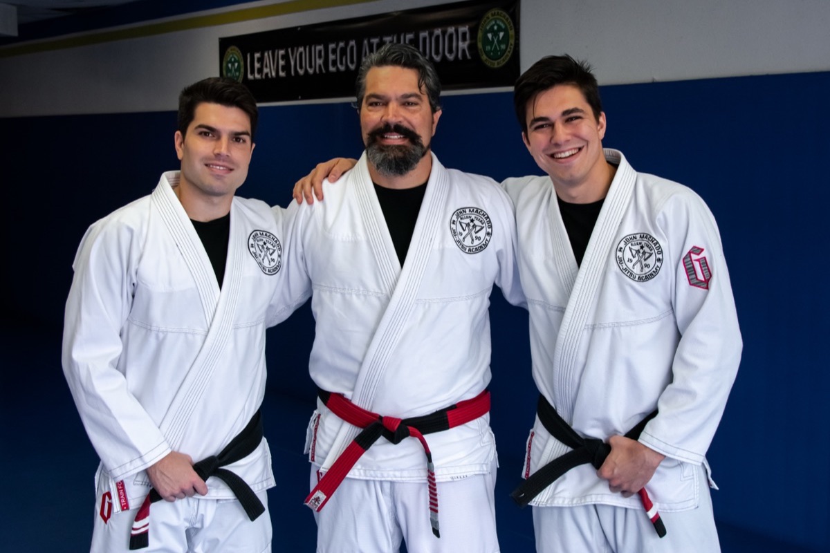 John with his father, Master John Machado, and his brother, Jean, at the John Machado Jiu-Jitsu Academy